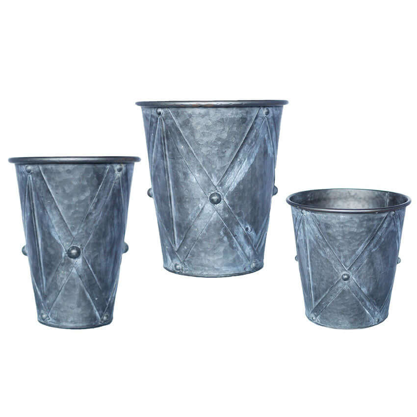 Three galvanized metal buckets of different sizes on a white background