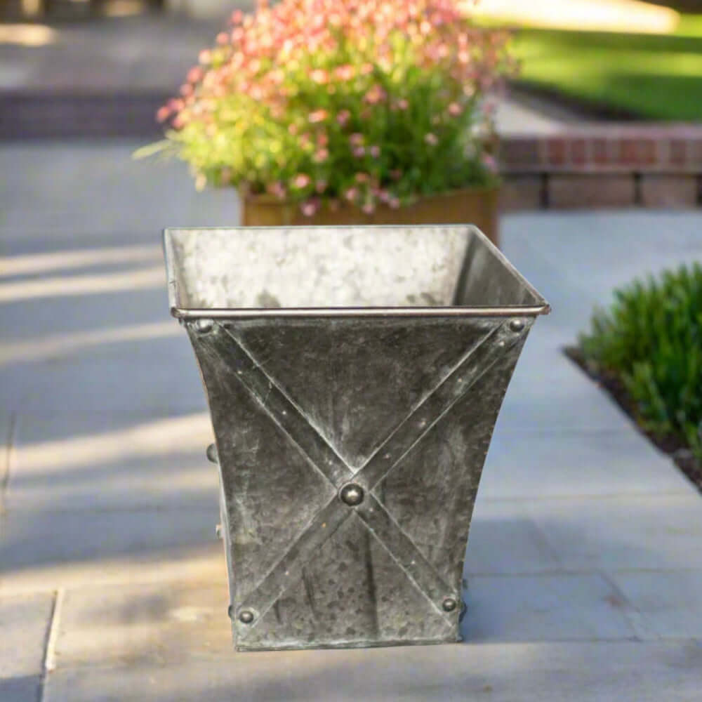 Metal planter with decorative crossbars on a patio