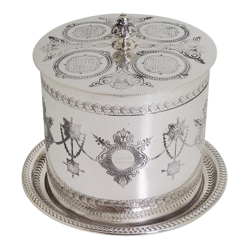 Decorative silver box with intricate engravings on a white background