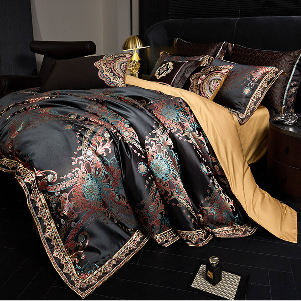 Luxurious bedspread with intricate patterns on a bed in a bedroom setting.