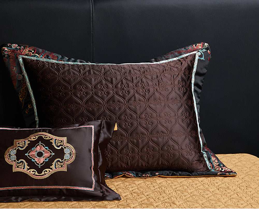 Decorative pillows with intricate patterns on a dark background
