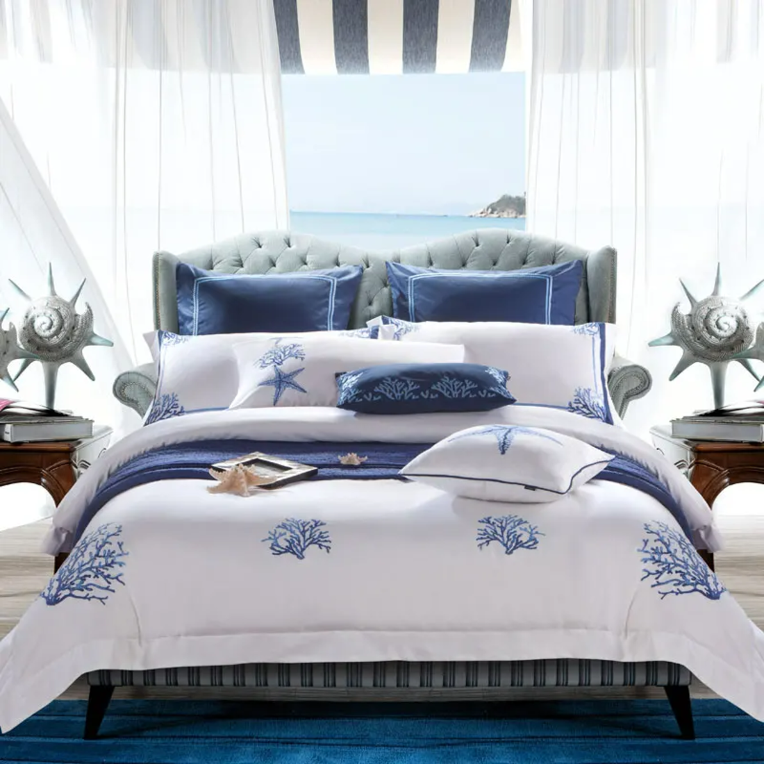 Bedroom with a bed featuring blue and white bedding, decorative pillows, and starfish accents.
