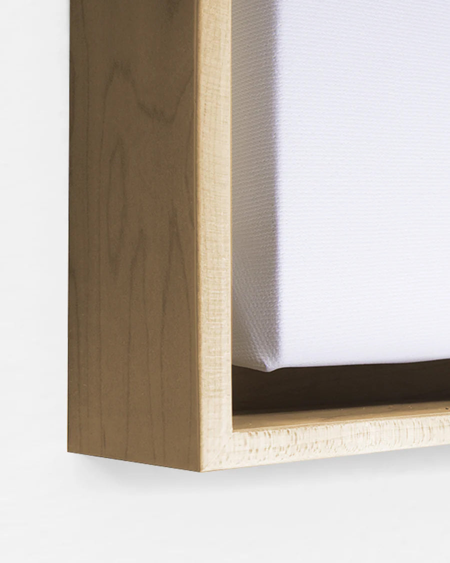 Wooden floating frame with white canvas on a white background