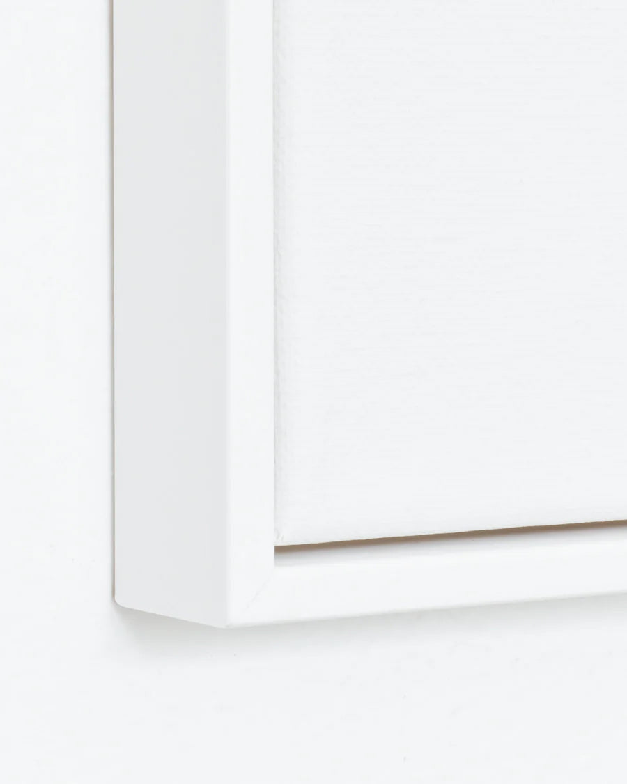 Close-up of a white canvas floating frame on a white background