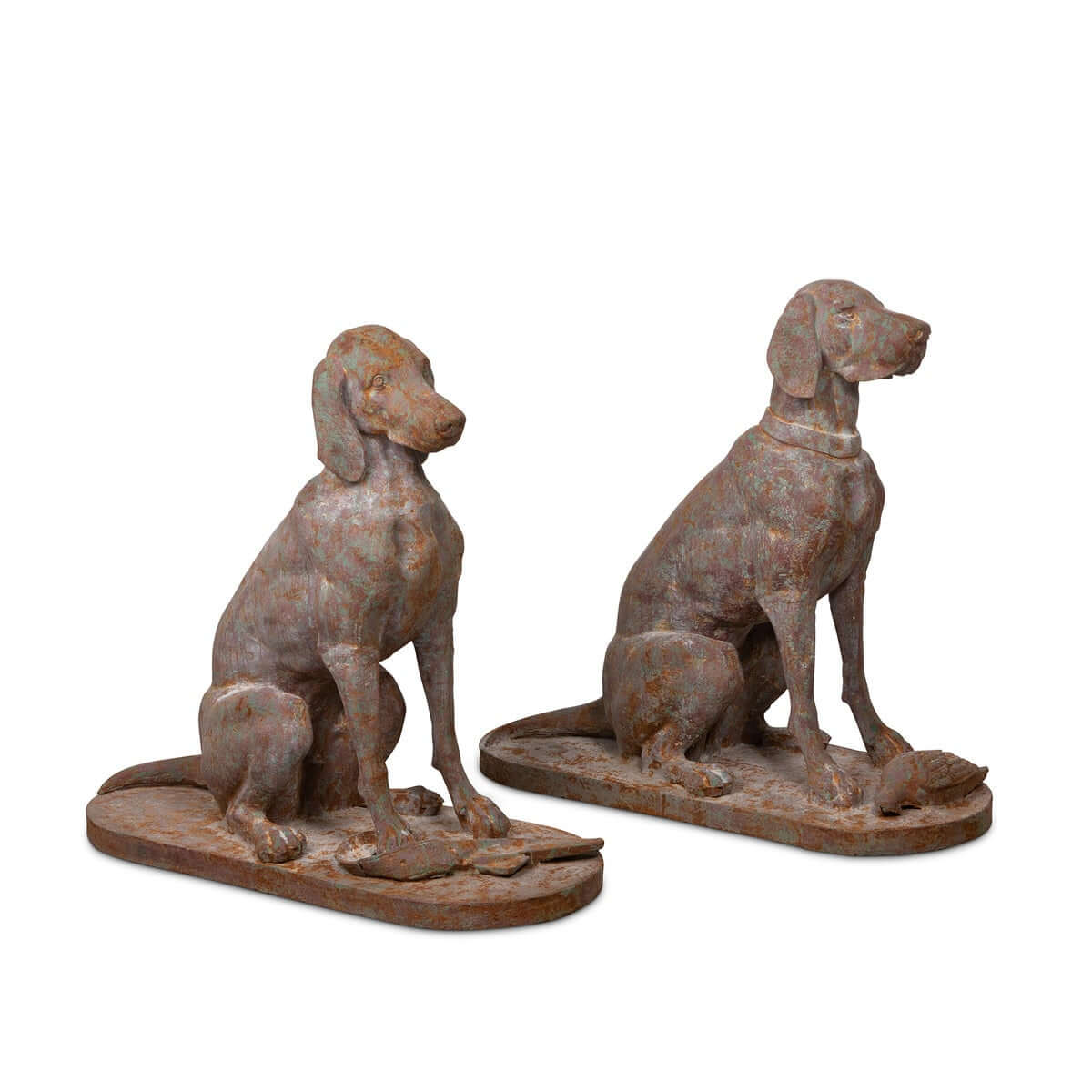 Two rusted metal dog sculptures on a white background