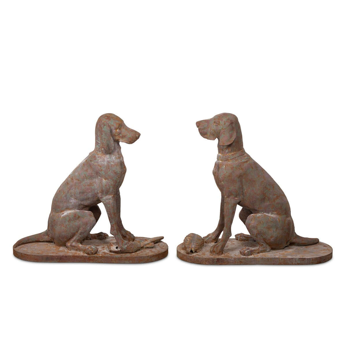 Two rusted metal dog statues on a white background
