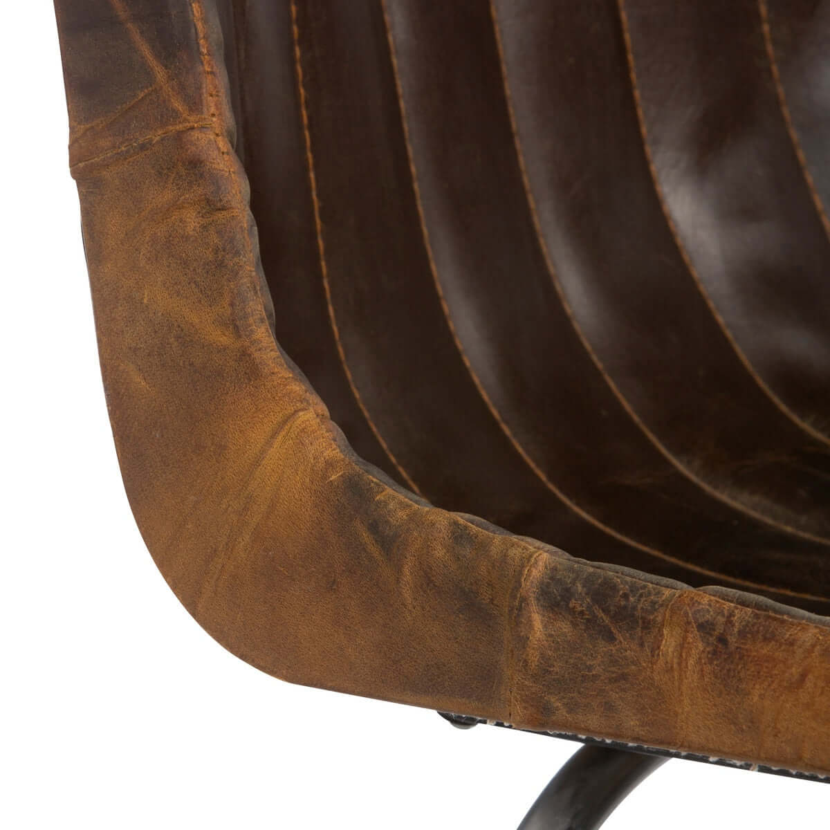 Close-up of a brown leather chair with visible wear and tear on a white background
