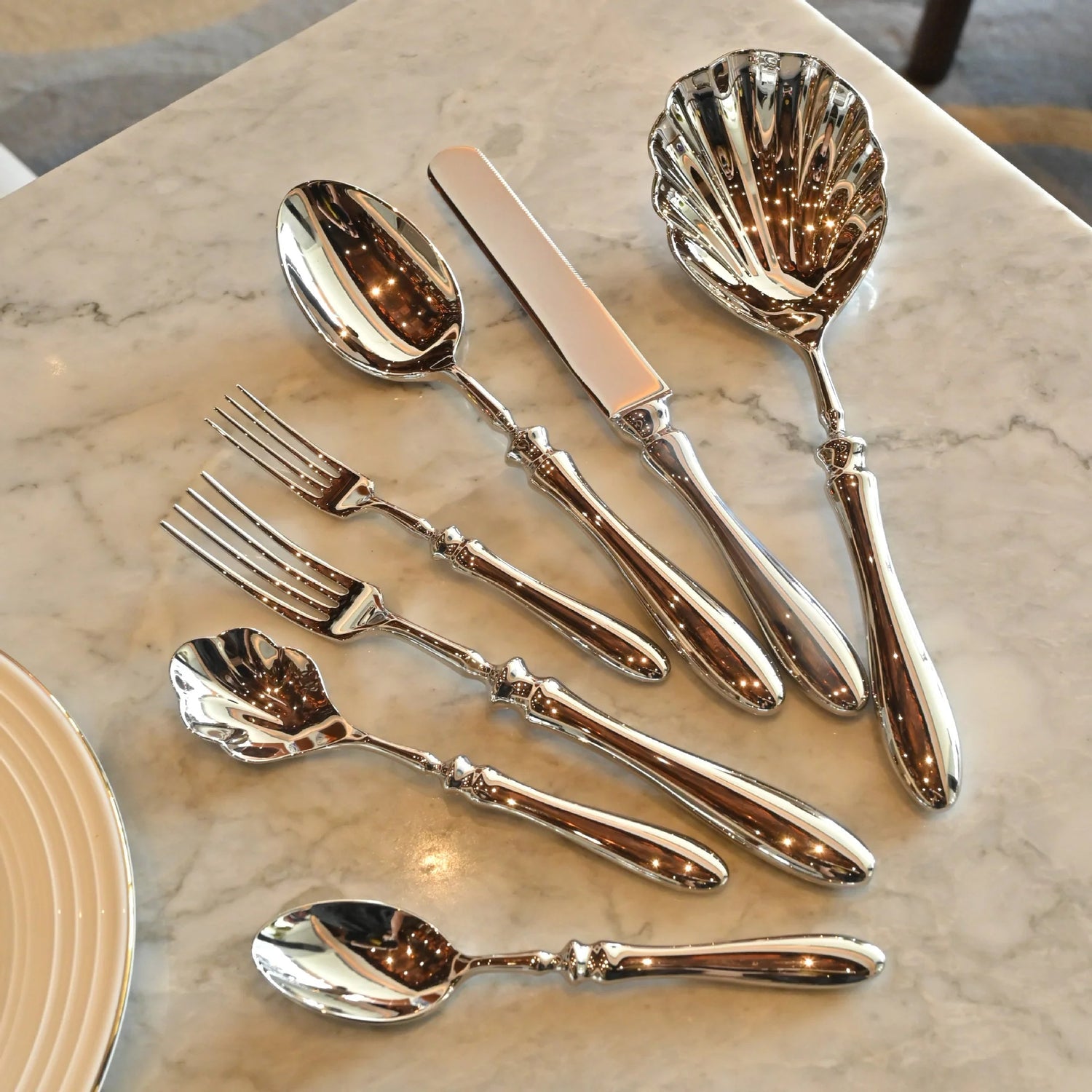 Silver cutlery set on a marble surface