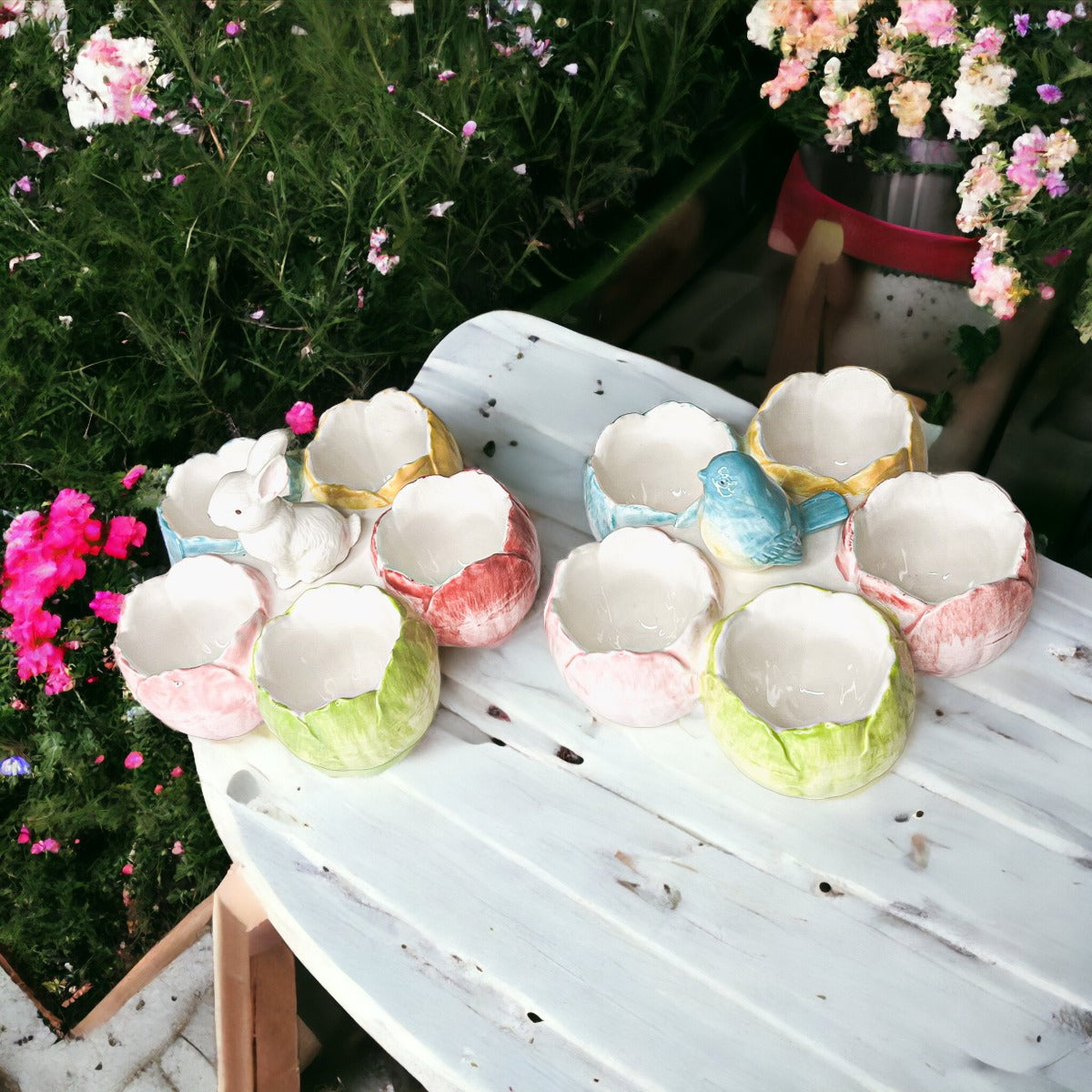 Decorative egg-shaped items on a table with flowers in the background