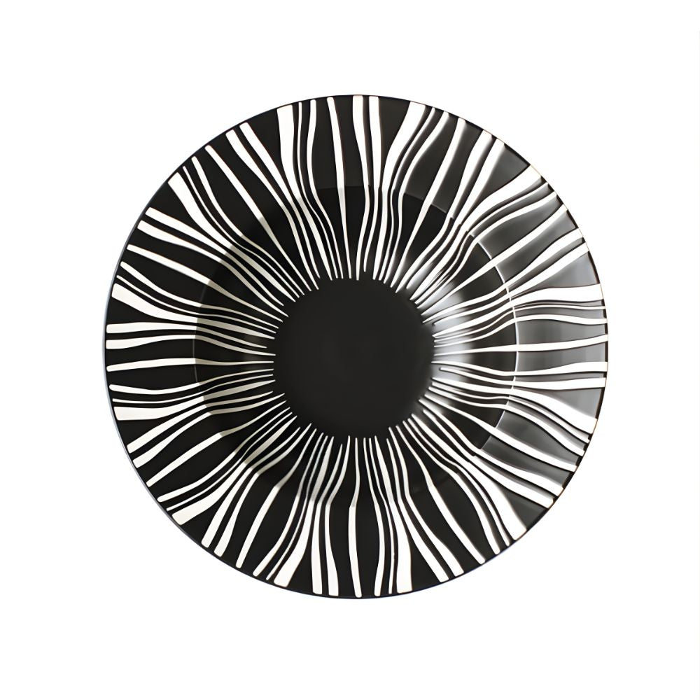 Black and white circular patterned object on a white background