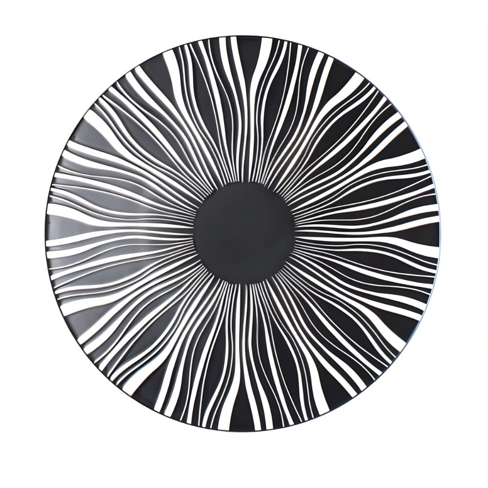 Round black and white patterned plate on a white background