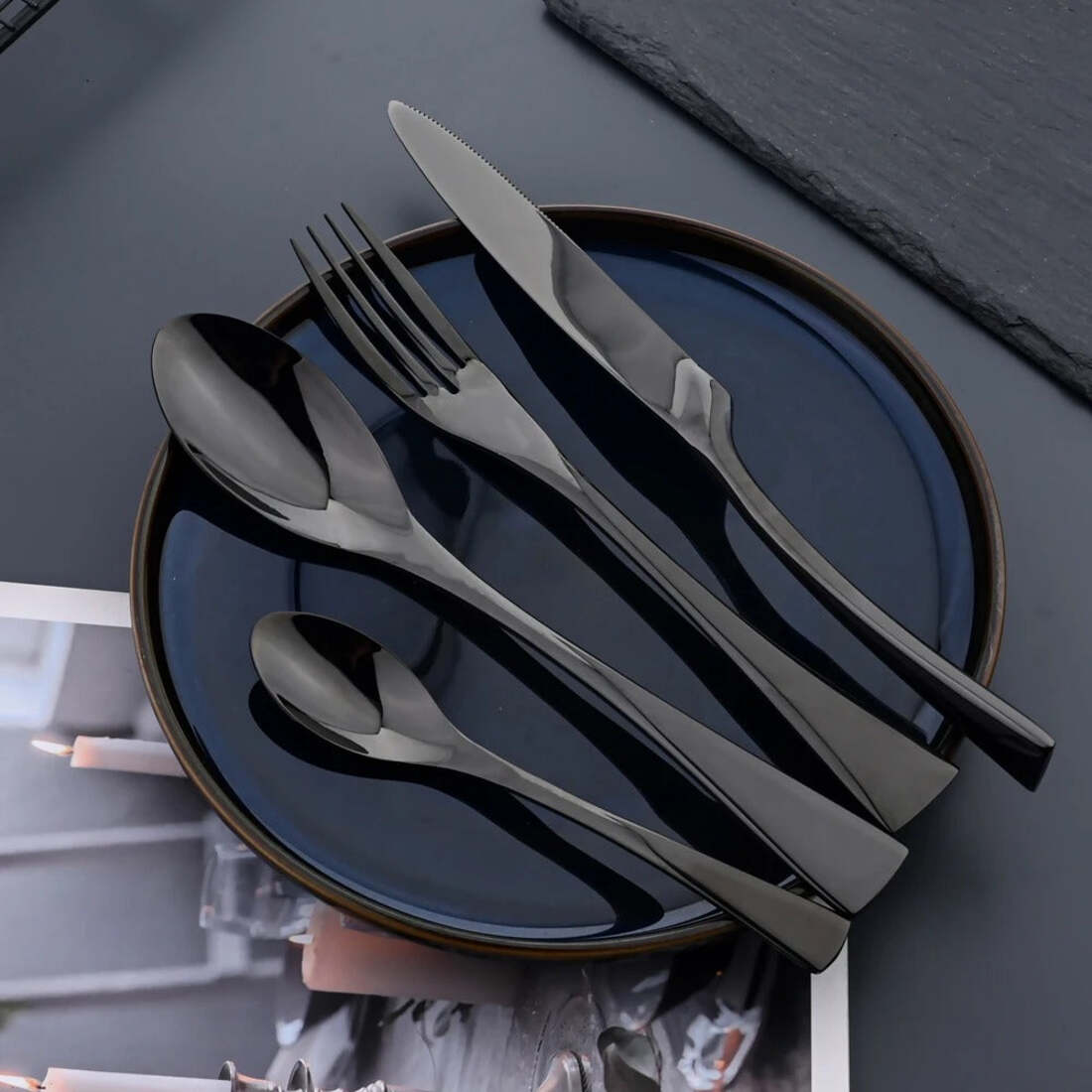 Black cutlery set on a dark surface