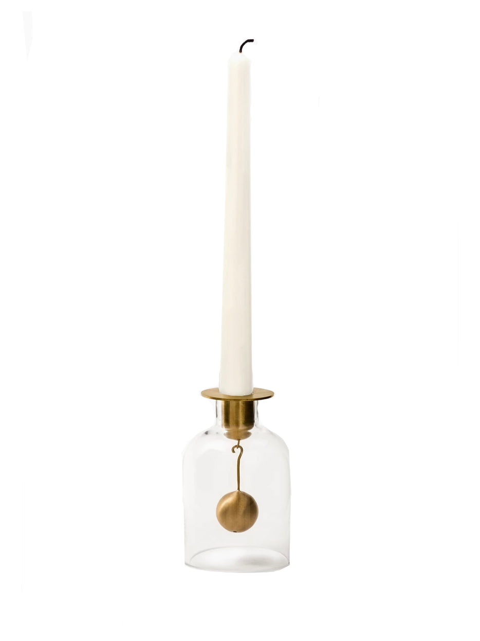 Klong bell candlestick holder with a white candle on a white background