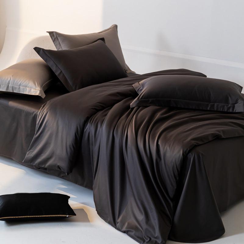 Dark brown satin bedding set on a bed with white pillows.