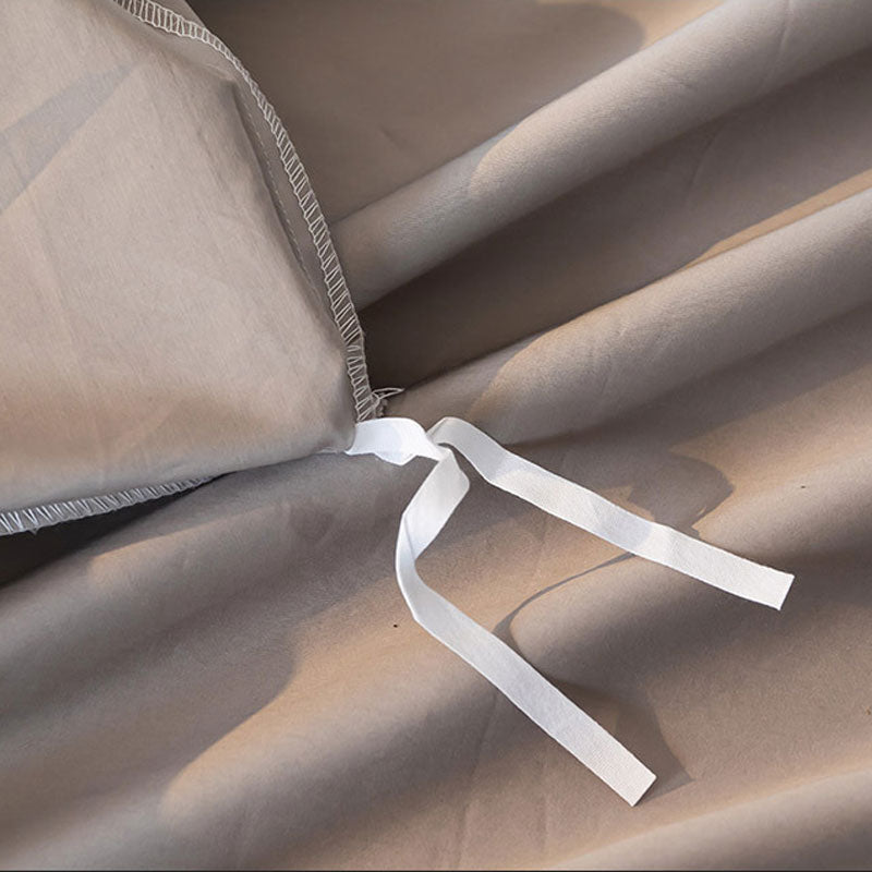 Close-up of beige fabric with a white ribbon tied around it