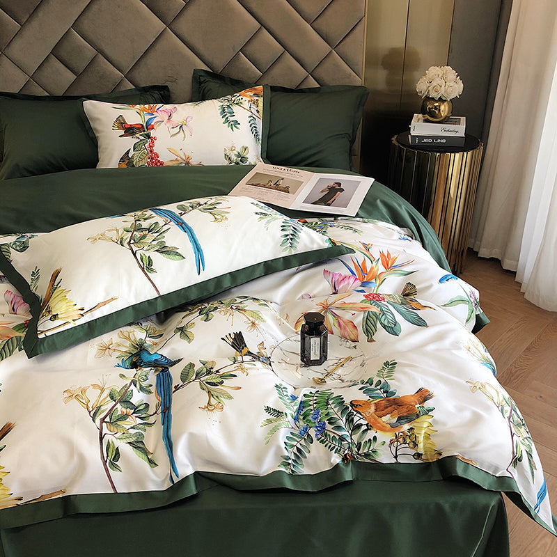 Floral and bird patterned bedding set on a bed with a decorative headboard.