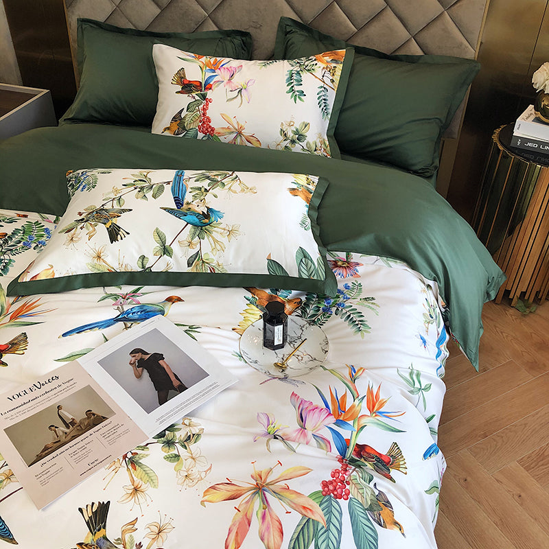 Floral bedding set with green pillows on a bed in a bedroom.