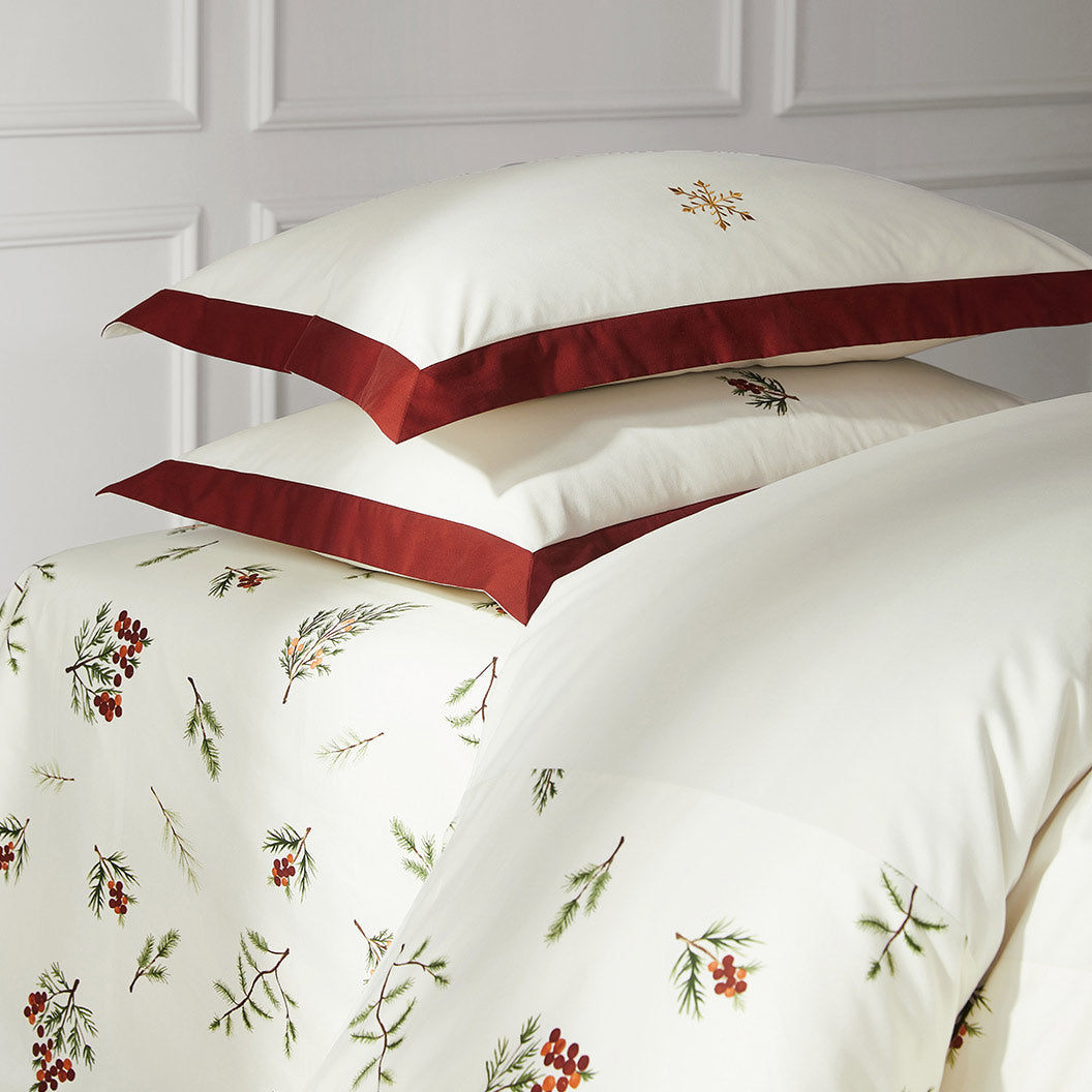 Floral-patterned duvet cover with red satin trim on a white background