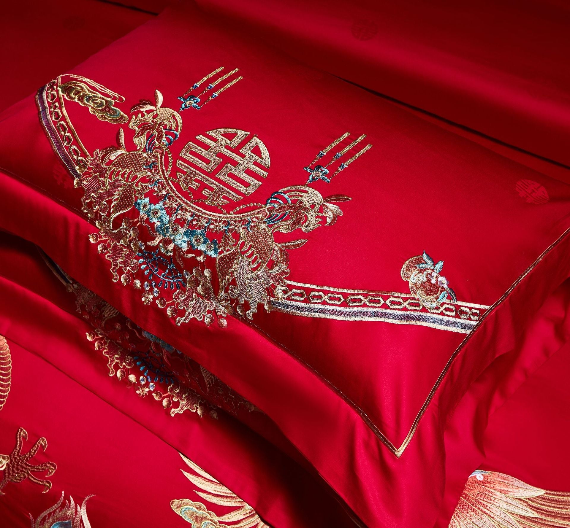 Red fabric with intricate gold embroidery of a dragon and floral patterns