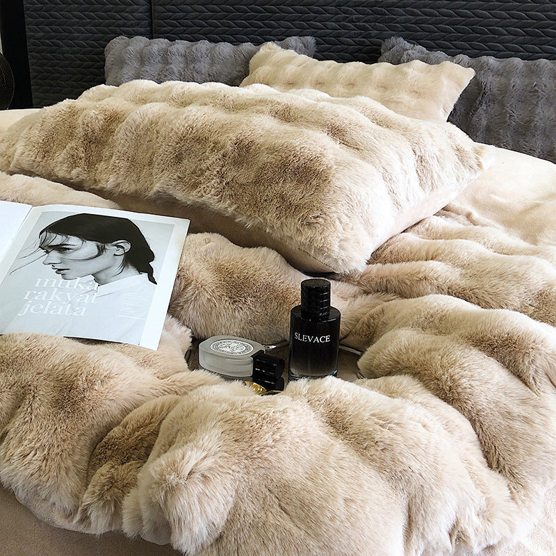 Beige faux rabbit fur bedding with a magazine and perfume bottles on a bed.