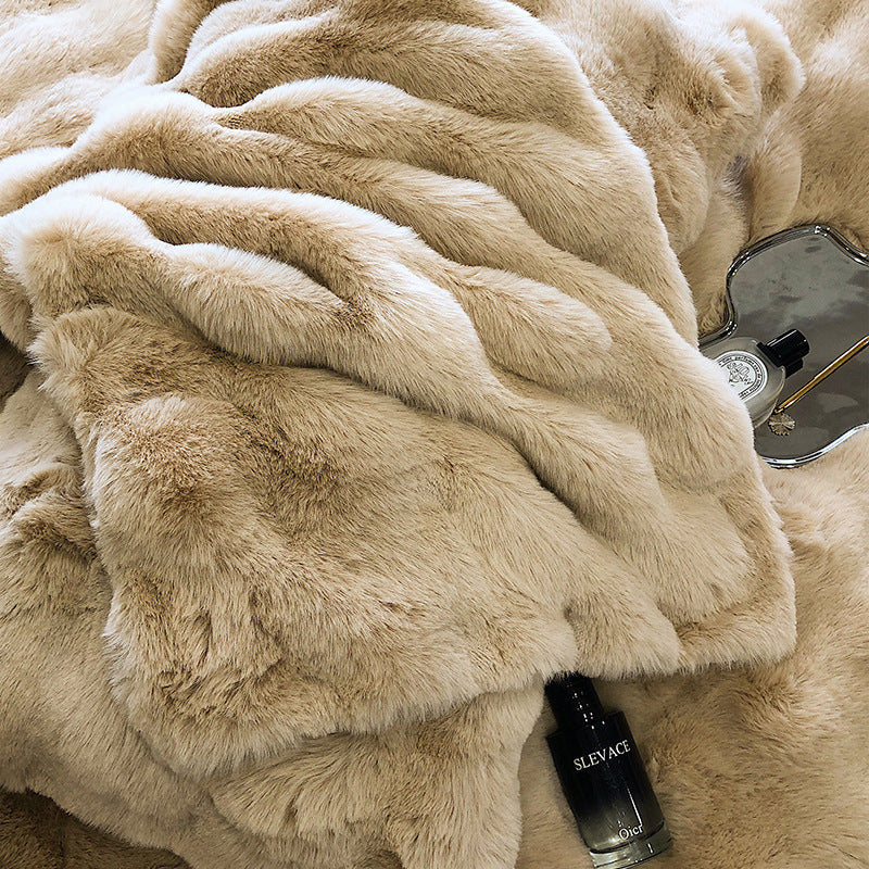 Close up of Beige faux rabbit fur bedding with a bottle of SLEVAQ on top