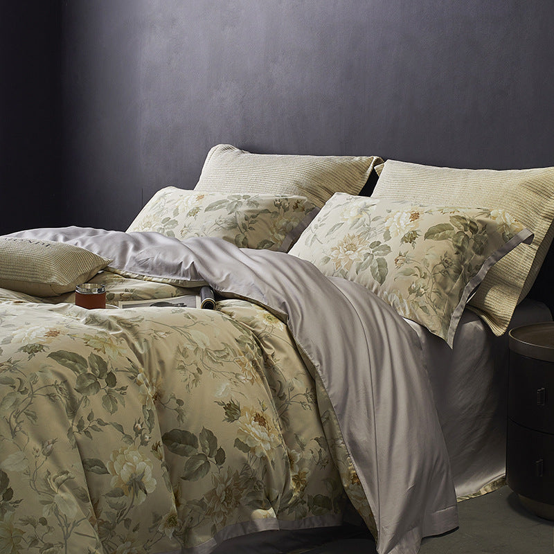 Floral patterned bedding set on a bed against a dark wall.