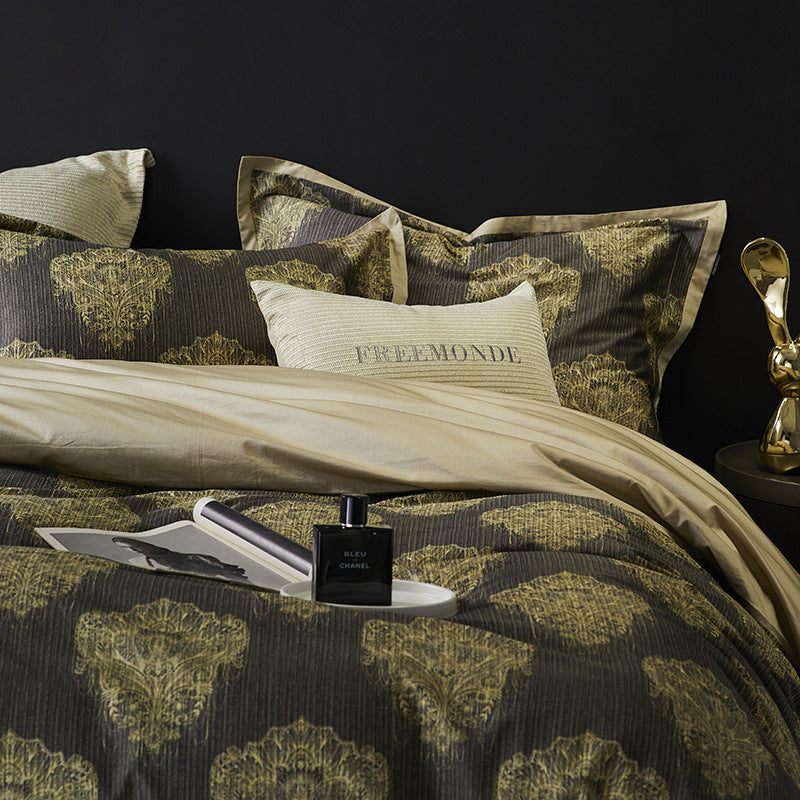Decorative bed with patterned bedding and pillow, against a dark background.