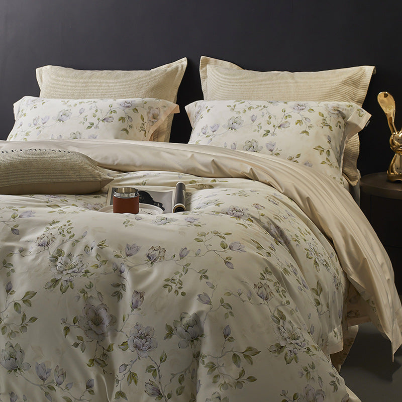 Floral bedding set on a bed with a dark background