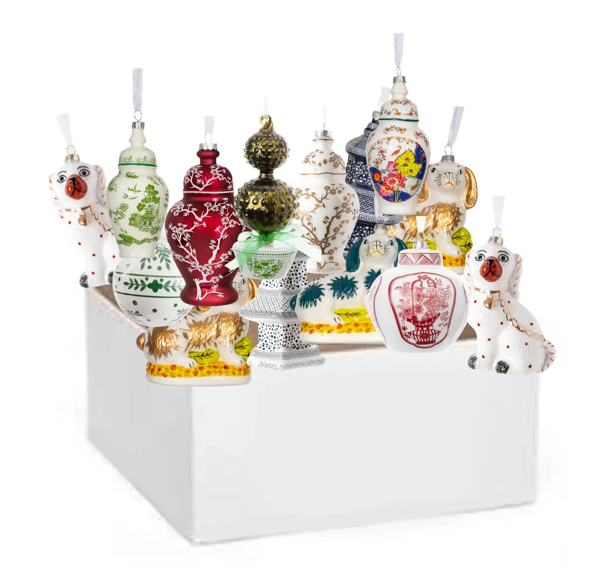 Collection of holiday ornaments including jars and figurines in a white box