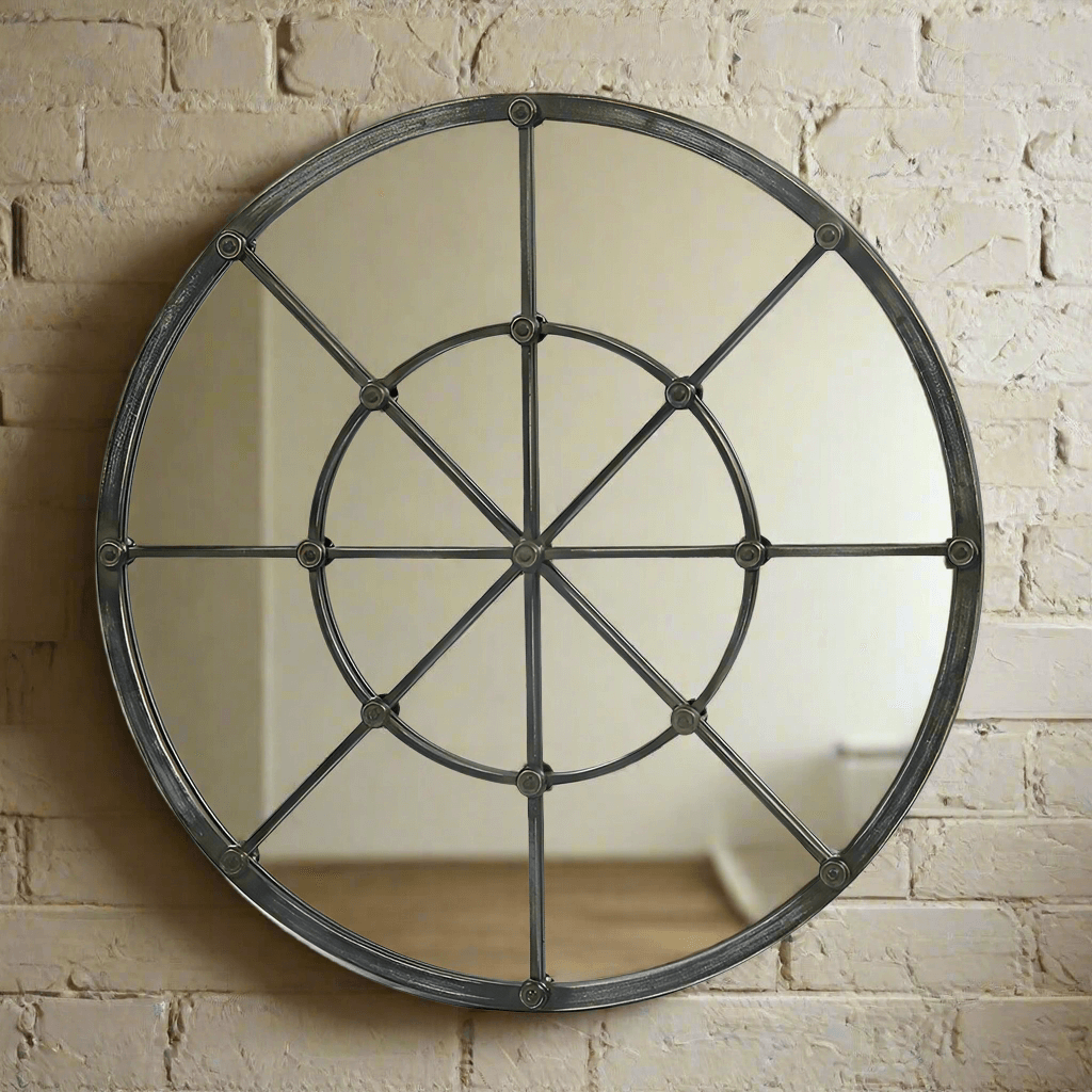 Round mirror with metal frame on a brick wall