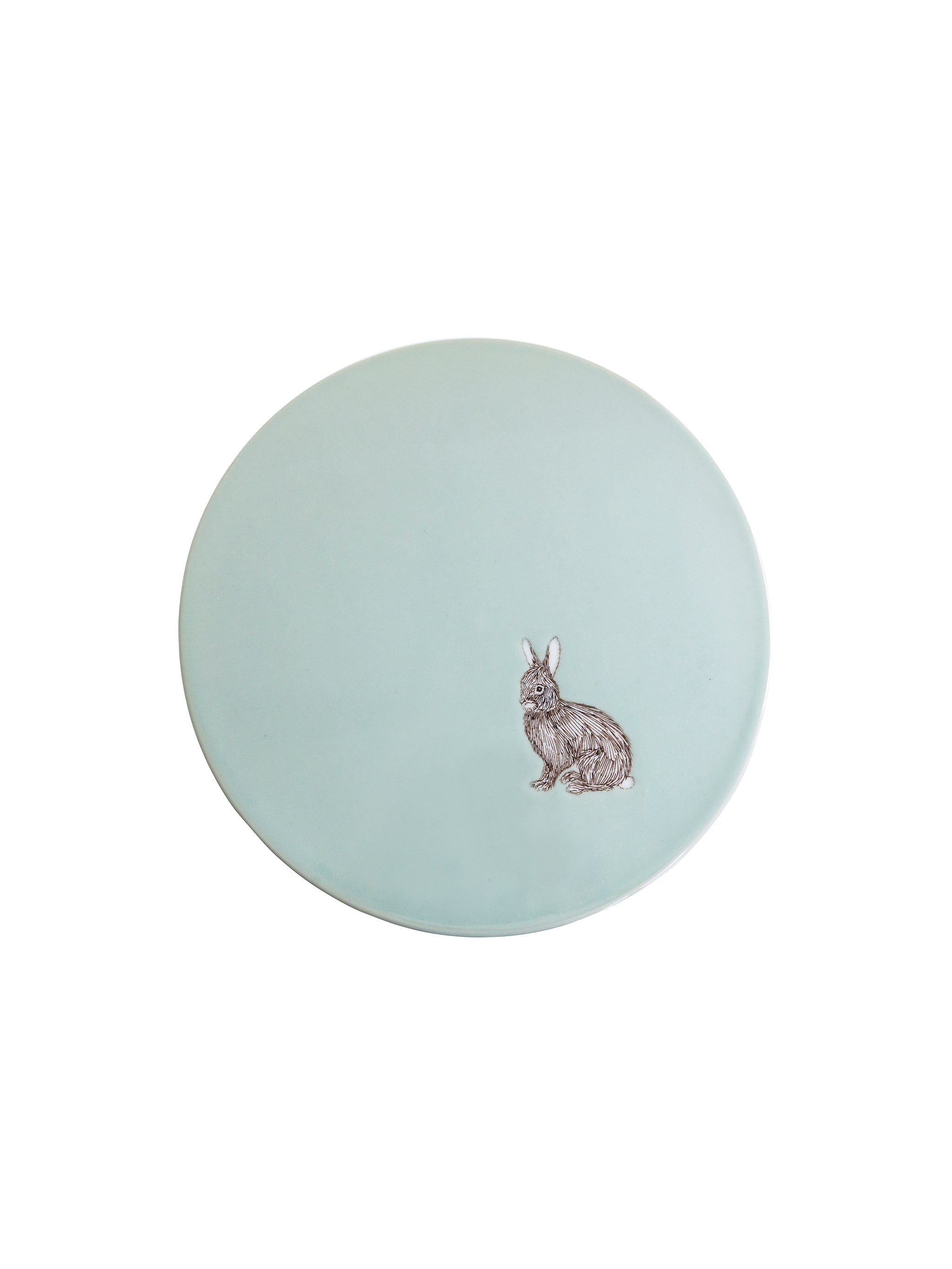 Round light blue cake stand with a rabbit motif on a white background