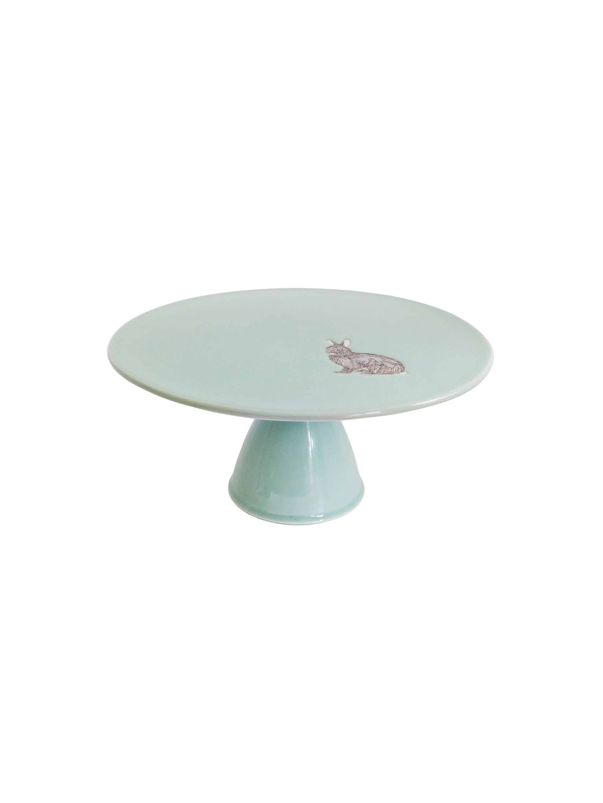 Light blue cake stand with a small decorative rabbit motif on a white background