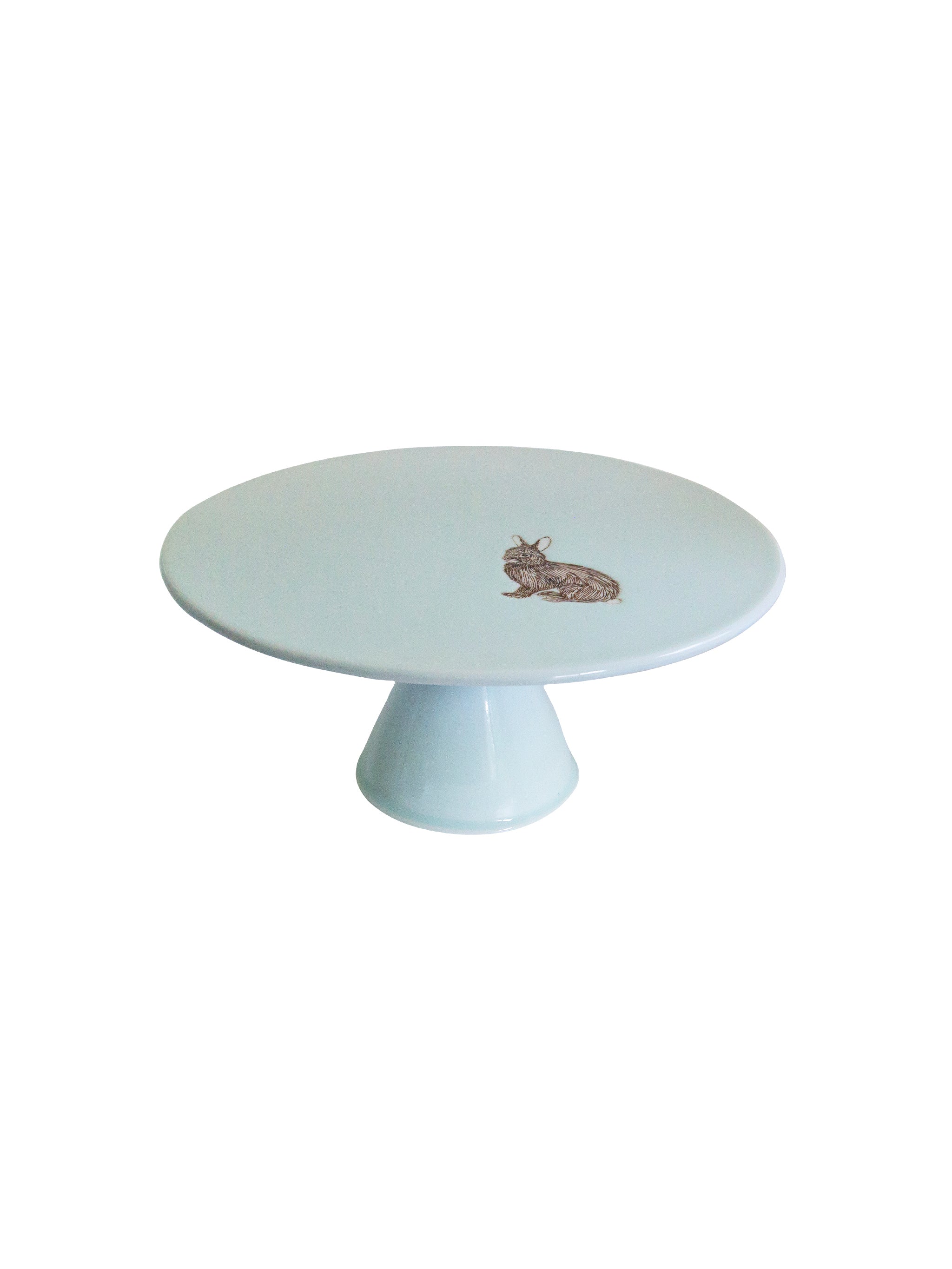 White cake stand with a small decorative rabbit design on a white background