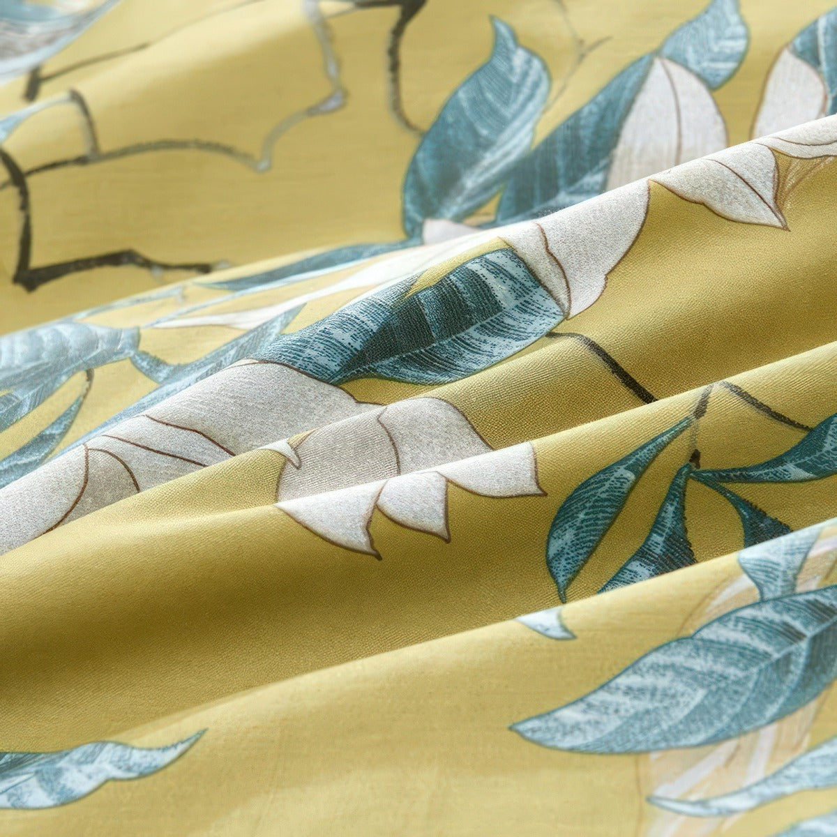 Close-up of fabric with leaf pattern on a yellow background