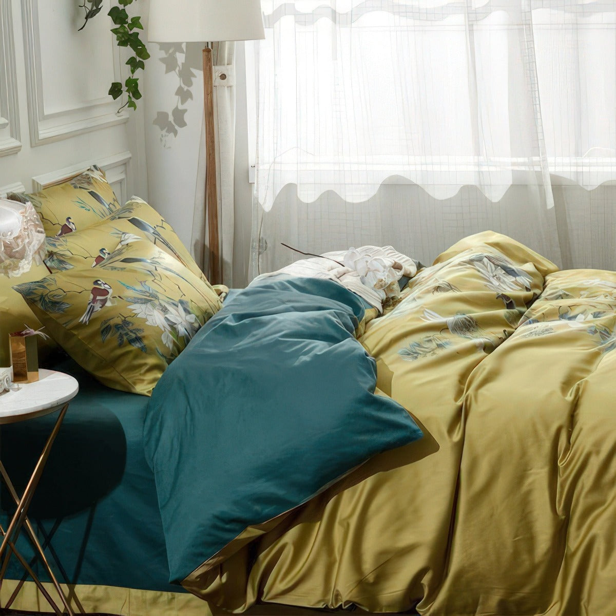 Bed with yellow and teal bedding in a bedroom setting