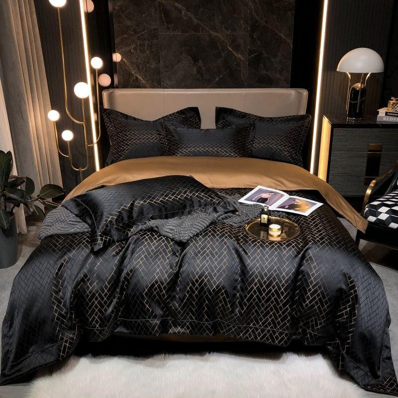 Bedroom with a bed featuring black bedding and decorative pillows, surrounded by modern decor elements.