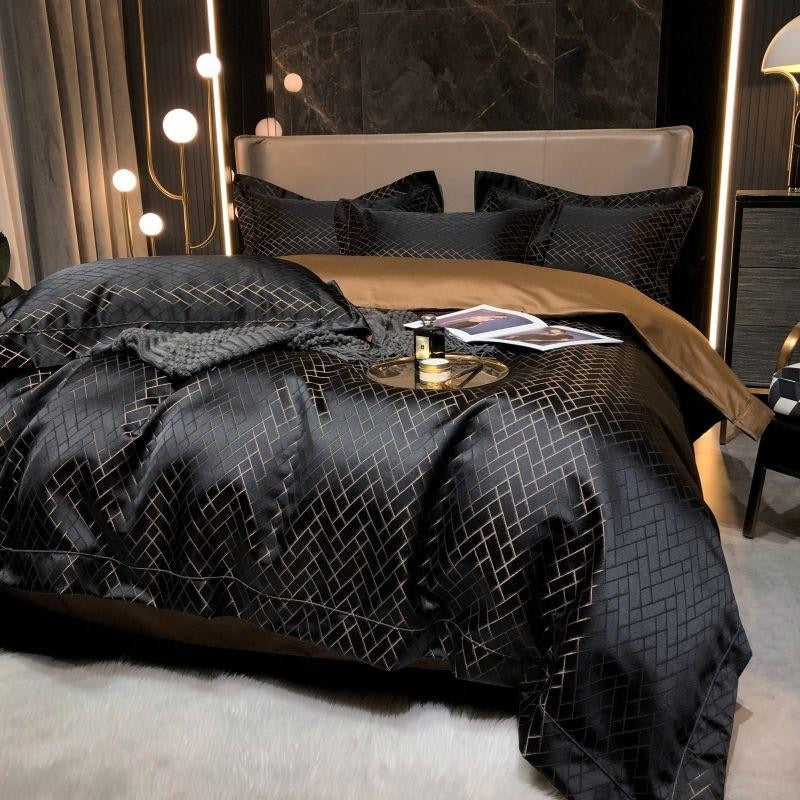 Luxury bedroom with a bed featuring black geometric bedding and gold accents.