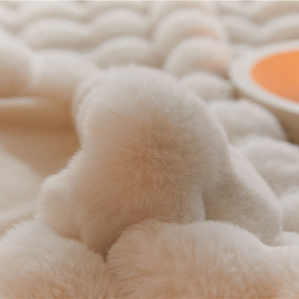 Close-up of a fluffy, beige textured surface with a small orange circle.