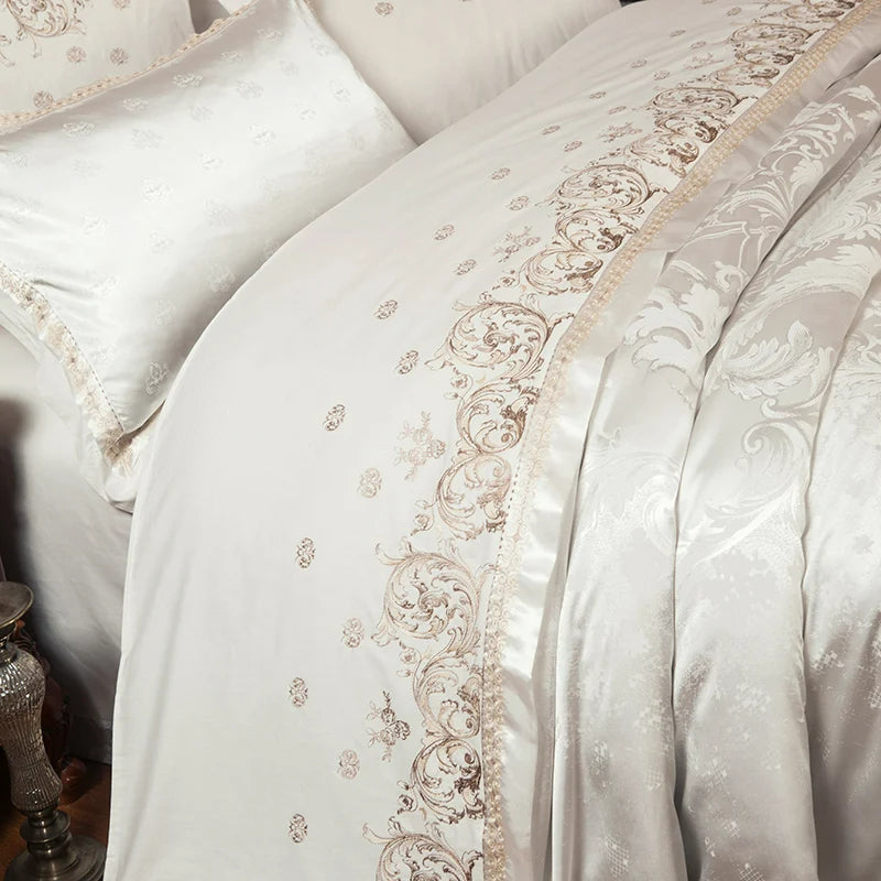 Close-up of a white embroidered bedspread with intricate patterns