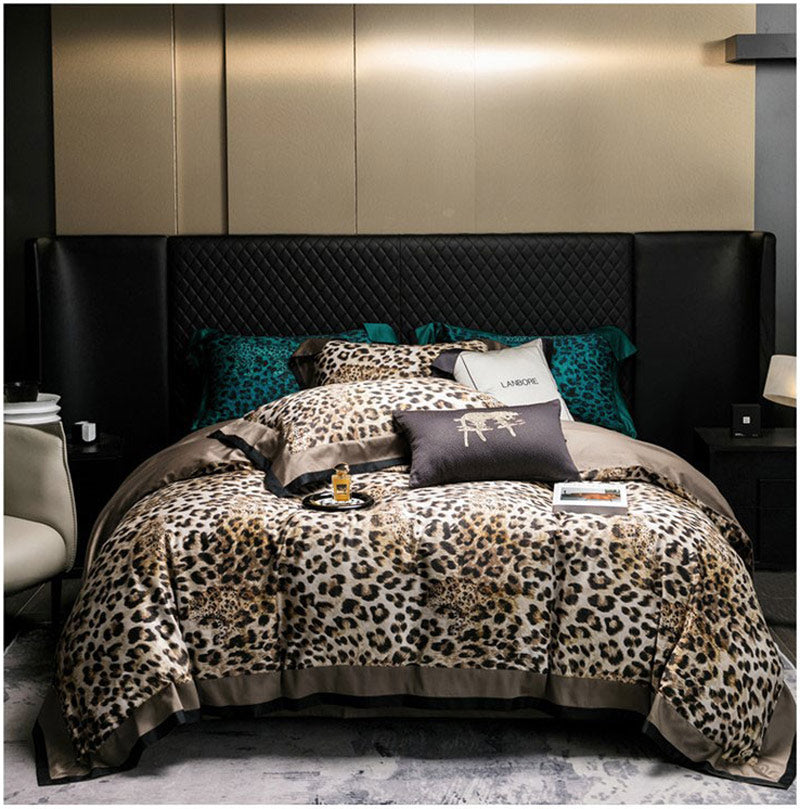 Bedroom with leopard print bedding and black upholstered headboard