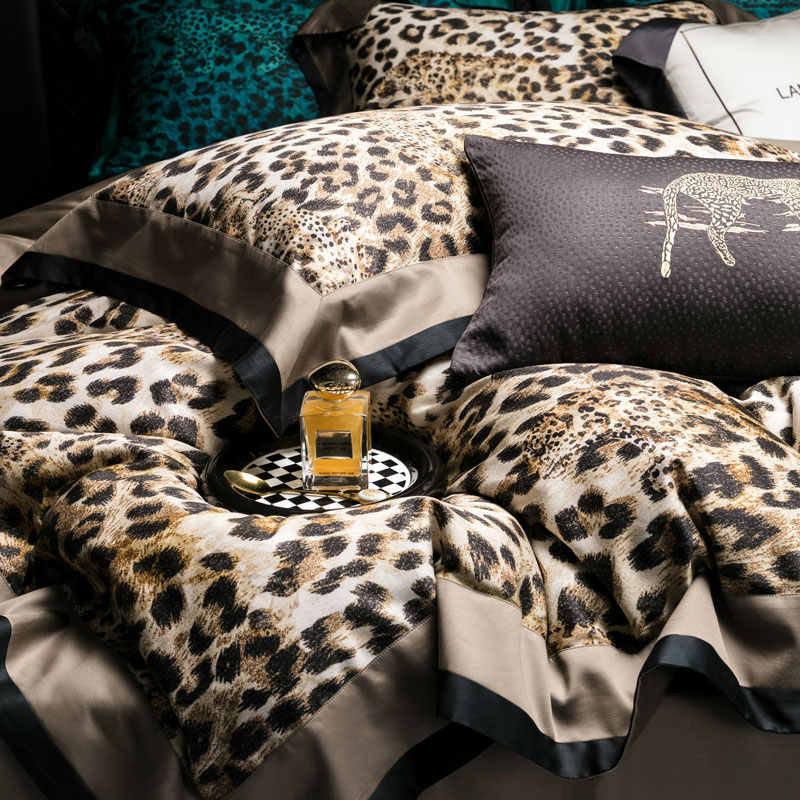 Leopard print bedding set with a bottle of perfume on a checkered coaster.