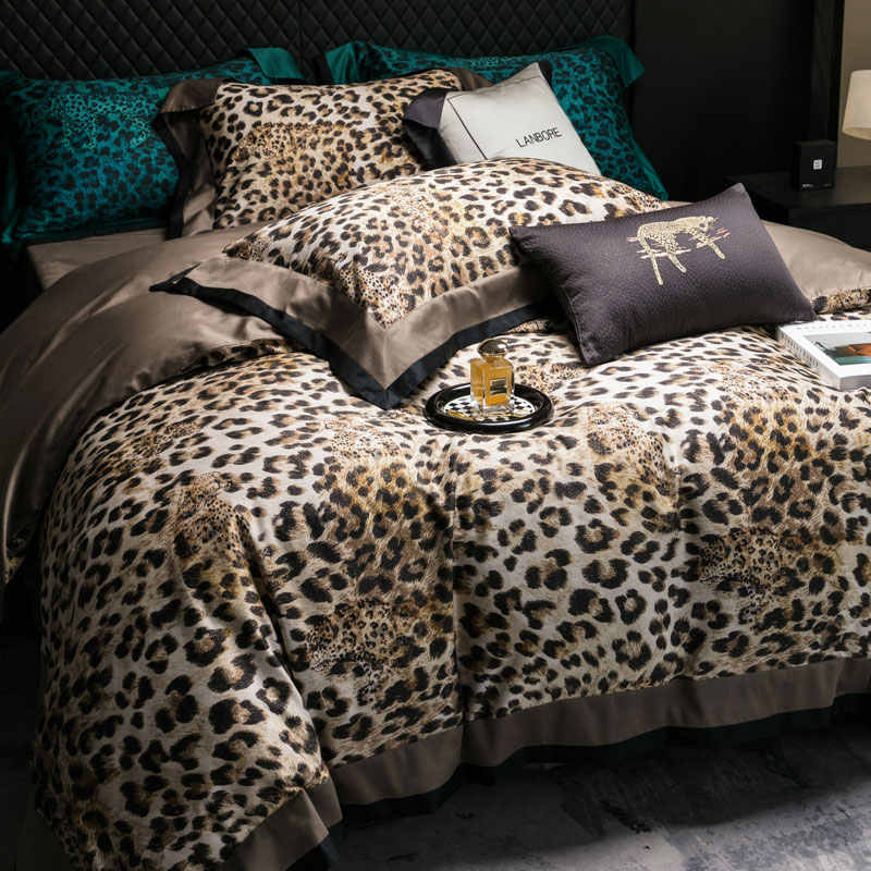 Bed with leopard print bedding and decorative pillows in a bedroom setting.