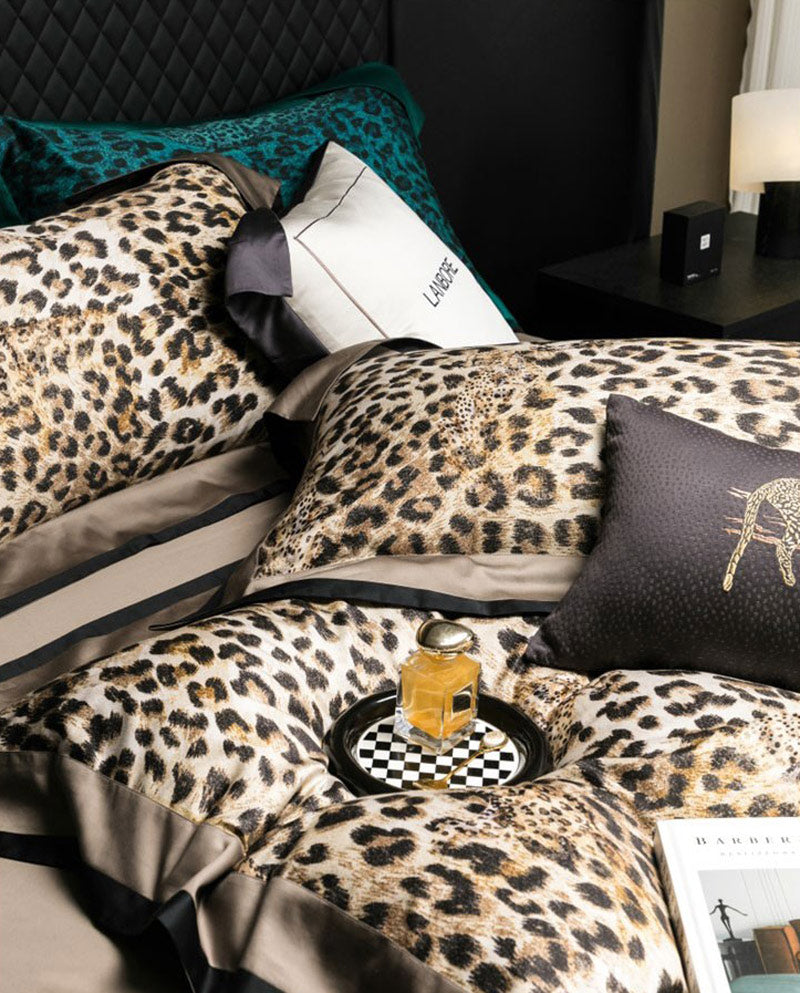 Leopard print bedding with a glass of wine on a checkered coaster.