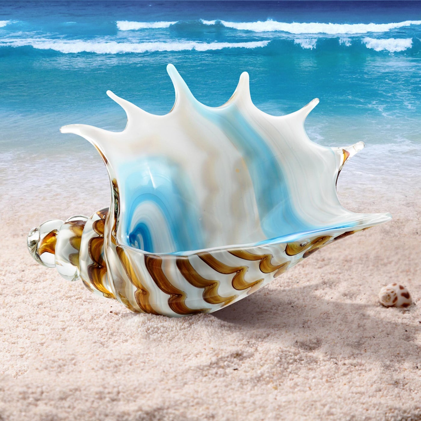 Colorful glass shell on a sandy beach with ocean waves in the background
