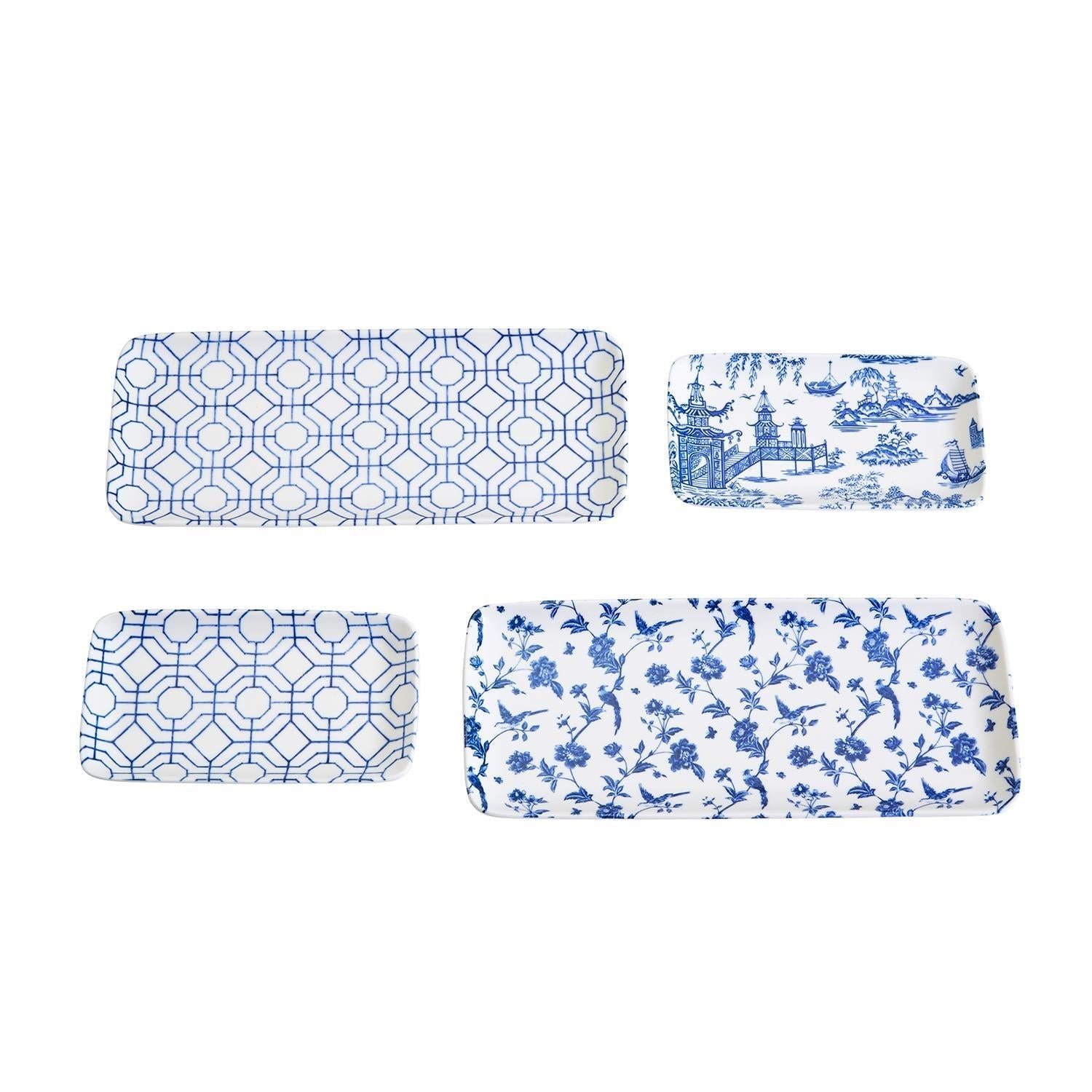 Four blue and white patterned trays on a white background