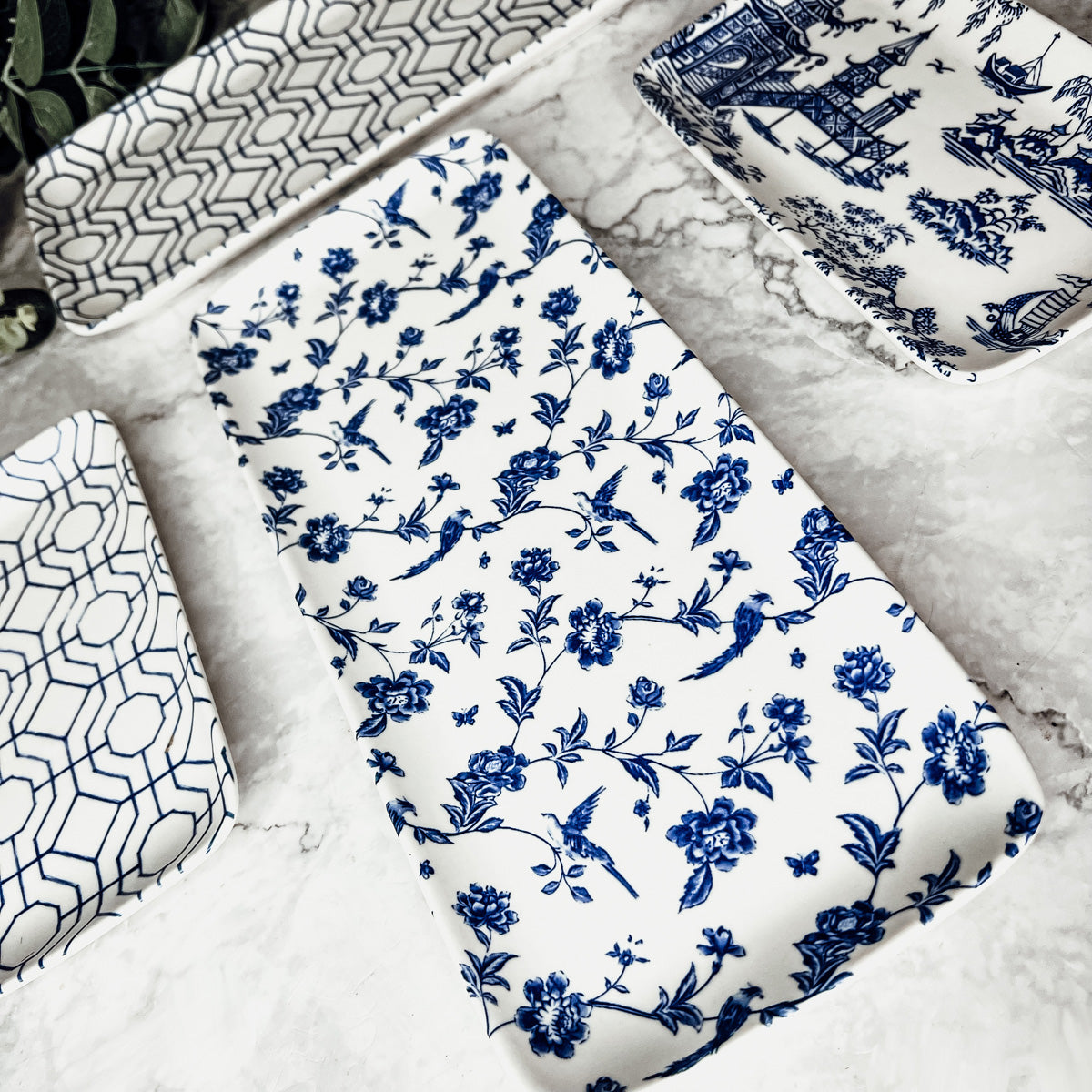 Closeup of a blue and white Chinoiserie serving tray on a marble surface