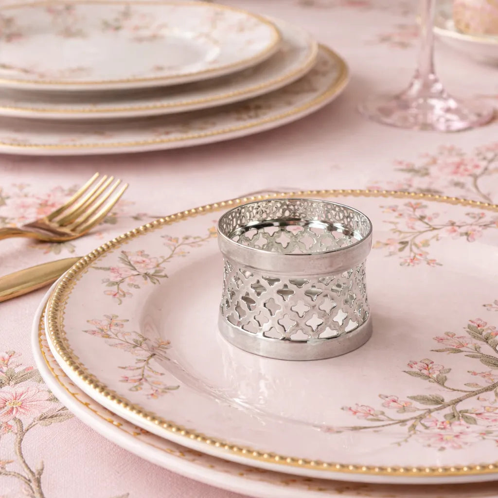 Silver plated napkin ring on pink chinoiserie table setting with gold trim