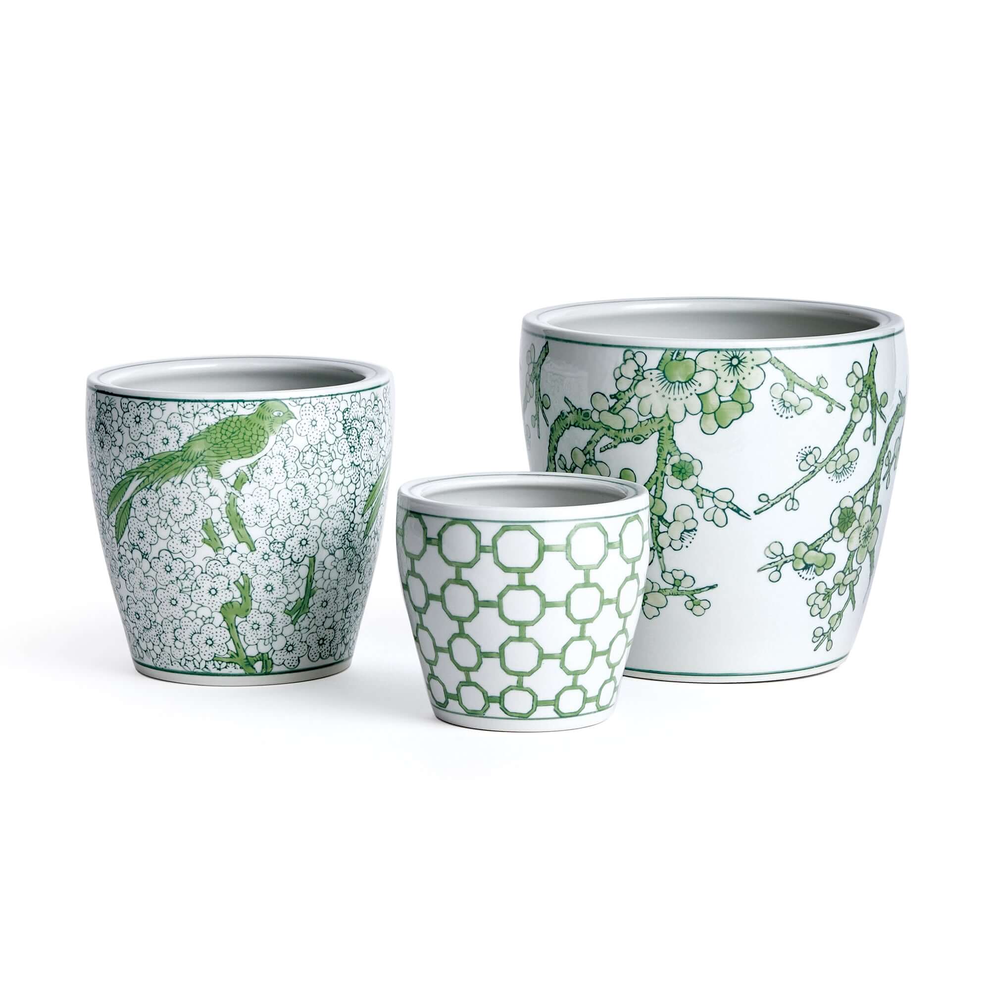 Three ceramic planters with green floral and geometric patterns on a white background
