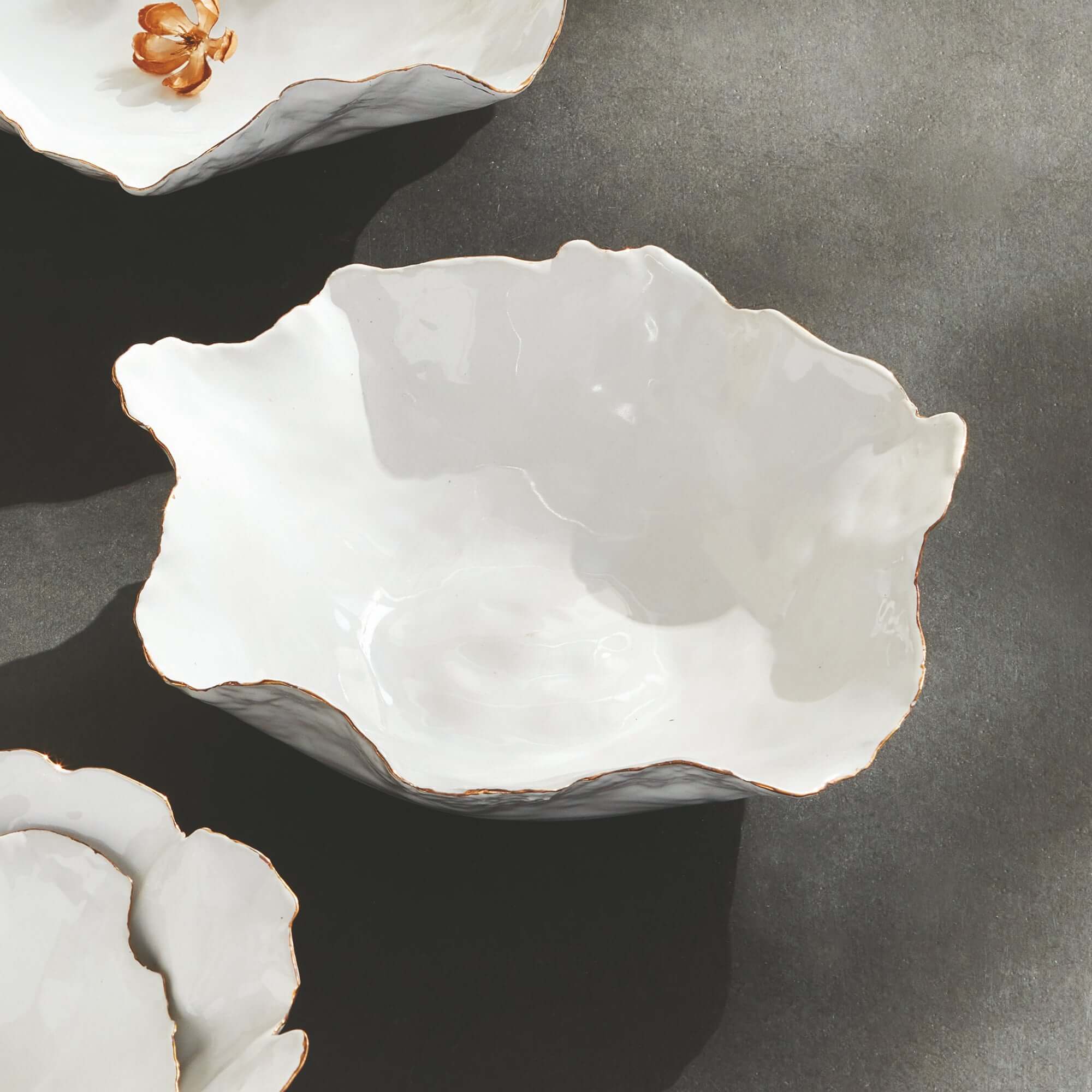 White ceramic bowl with textured surface on a dark gray background