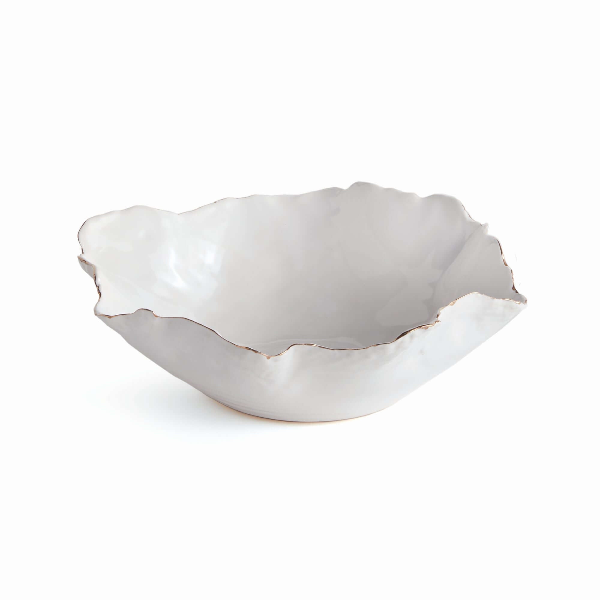 White ceramic bowl with scalloped edge on a white background